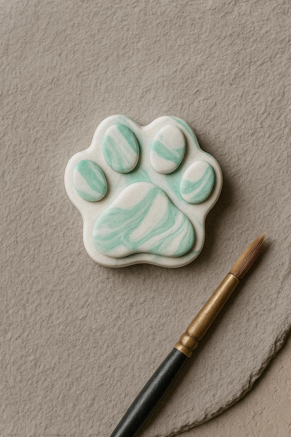 Marbled mint and white cat paw magnets made from air-dry clay, styled on a minimalist background.