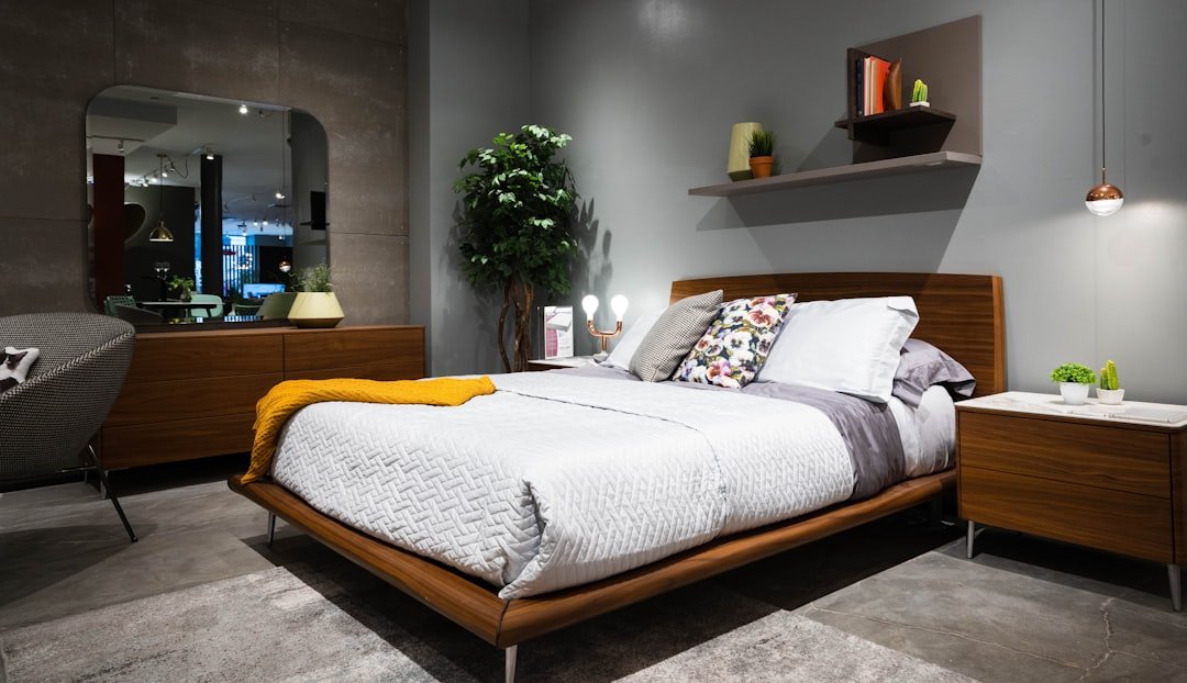 Bedroom with coordinated dark wood bed and nightstands styled with a mix of classic and contemporary decor