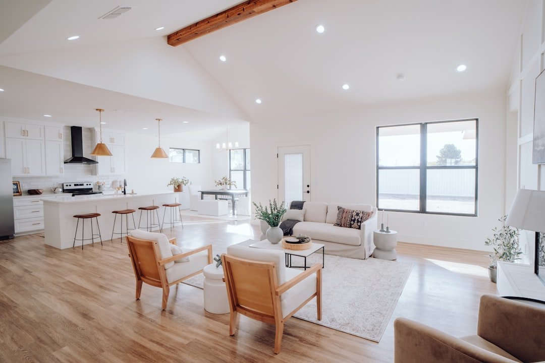 Cohesive open-concept colors and materials — photo by Bailey Alexander on Unsplash Open-concept kitchen and living room connected by a neutral palette, warm wood and coordinated finishes