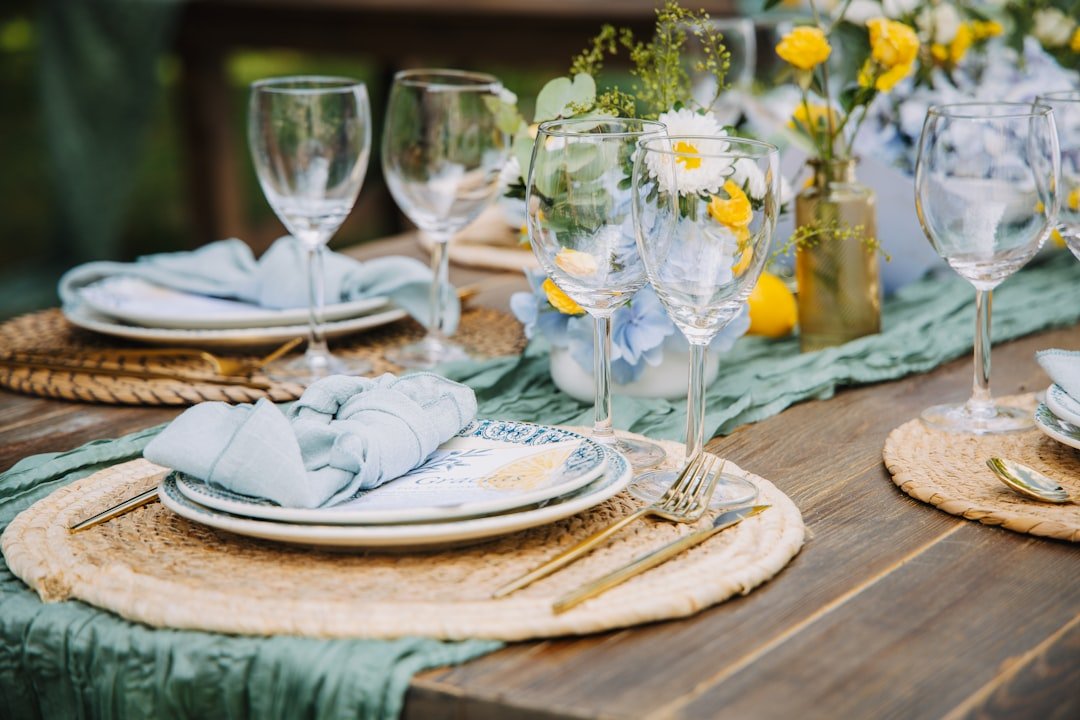 Elegant garden party table decor with flowers, candles and coordinated place settings