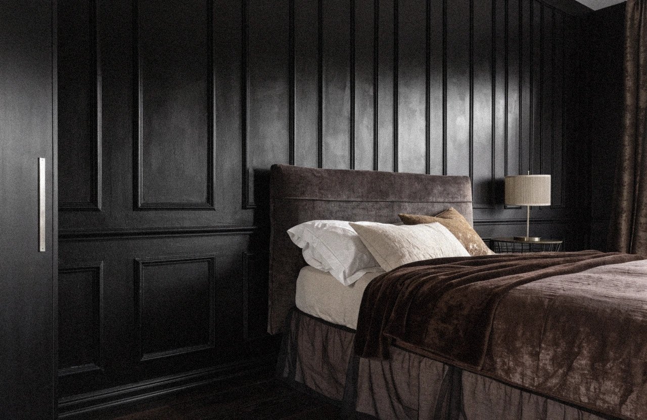 Black feature wall bedroom with decorative panel molding and neutral decor