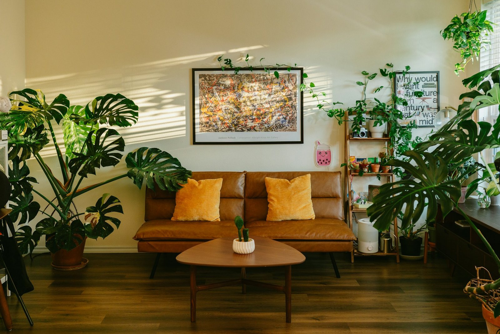 Sunlit brown living room with lush green plants, natural wood furniture and layered earthy textures