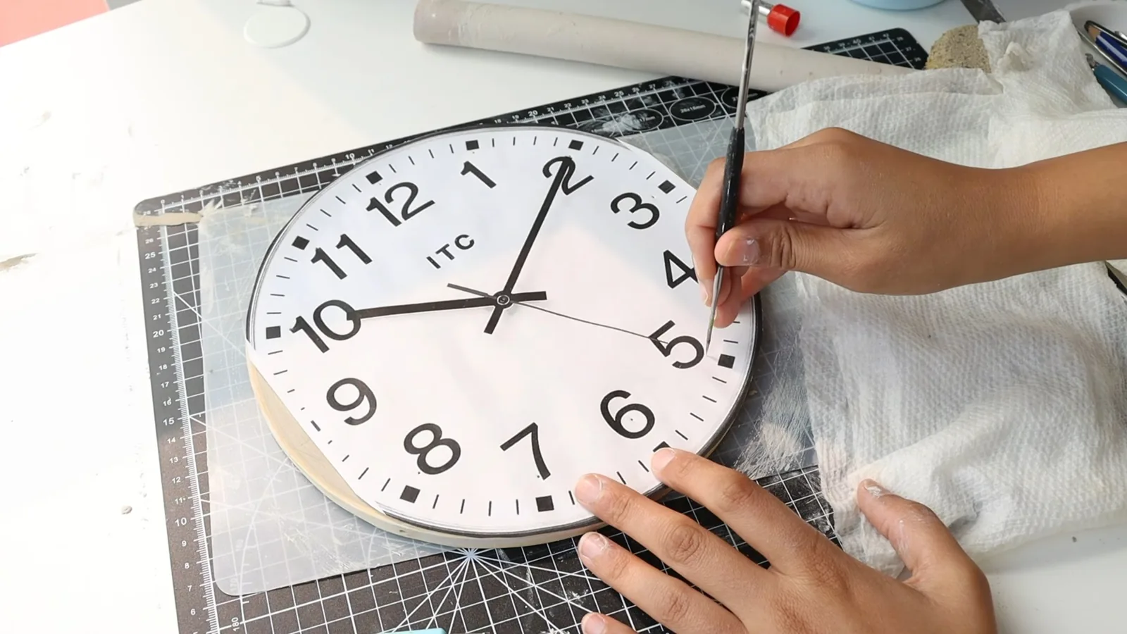 Hand shaping clay numbers for a clock dial