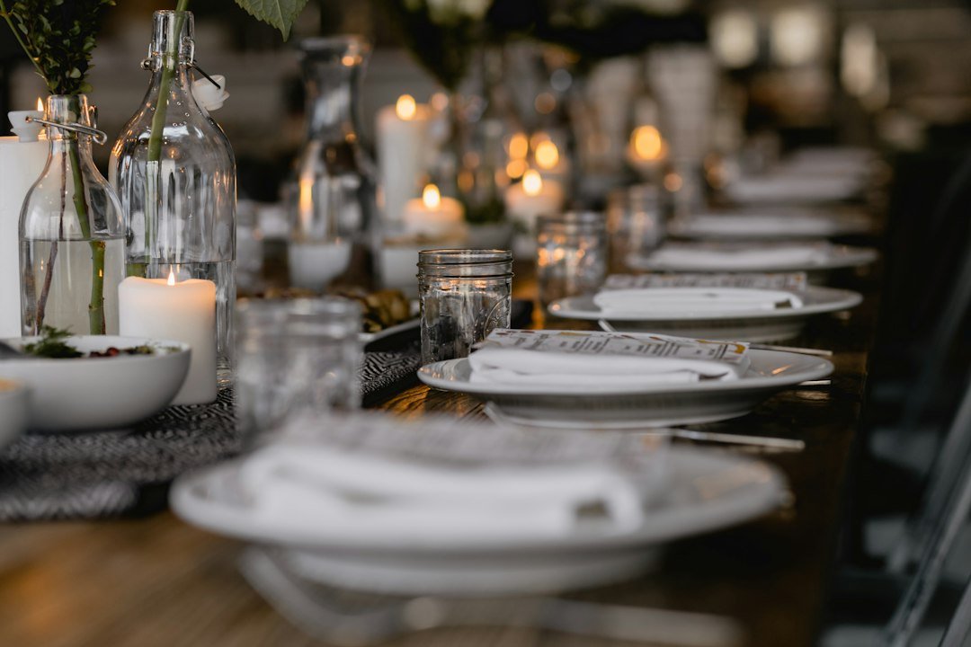 Elegant dining table with taper candles and simple place settings