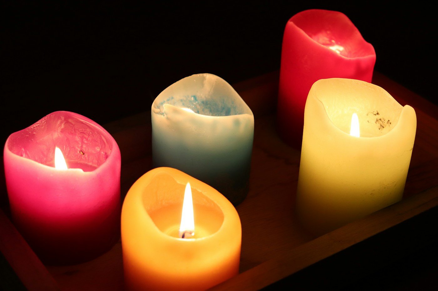 Artful display of candle holders and candles styled on a tray in a colorful interior