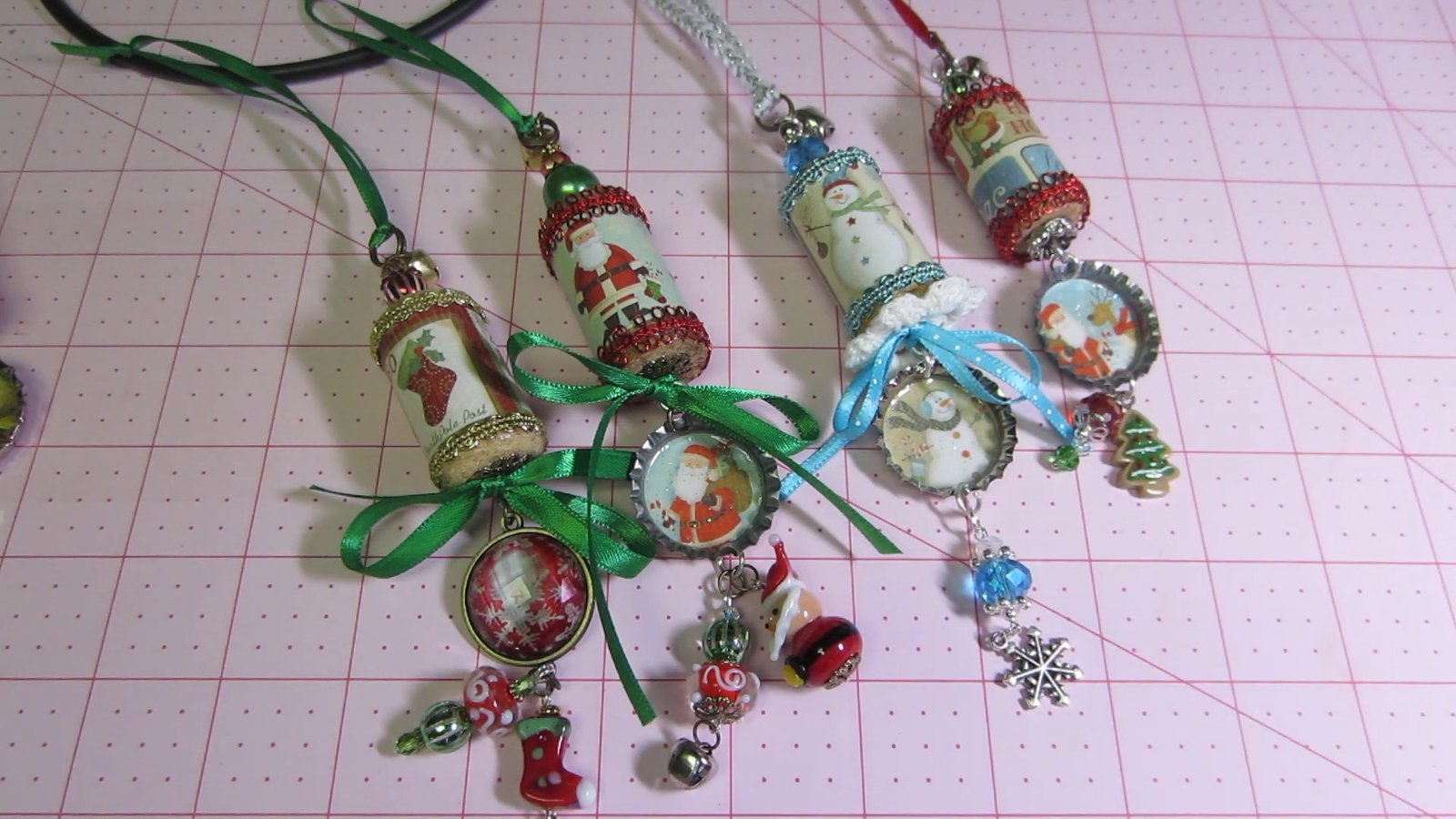 A collection of decorated wine cork Christmas ornaments with bottle-cap pendants and bead drops