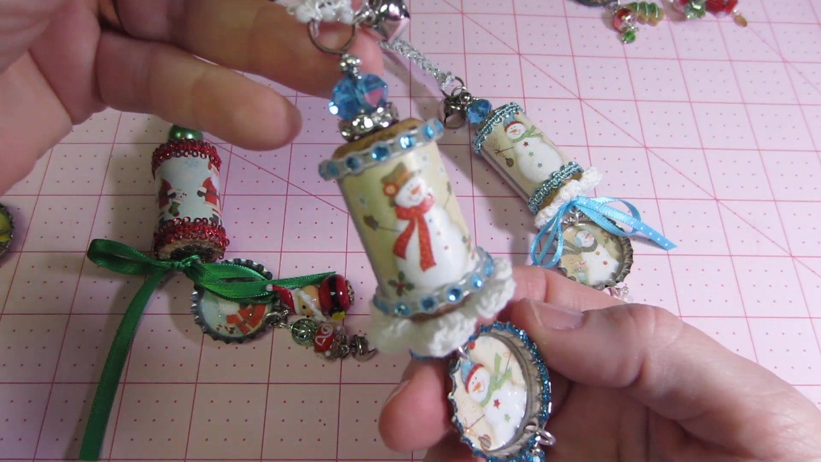 Snowman wine cork ornament with pale blue trim and a small bottle-cap pendant